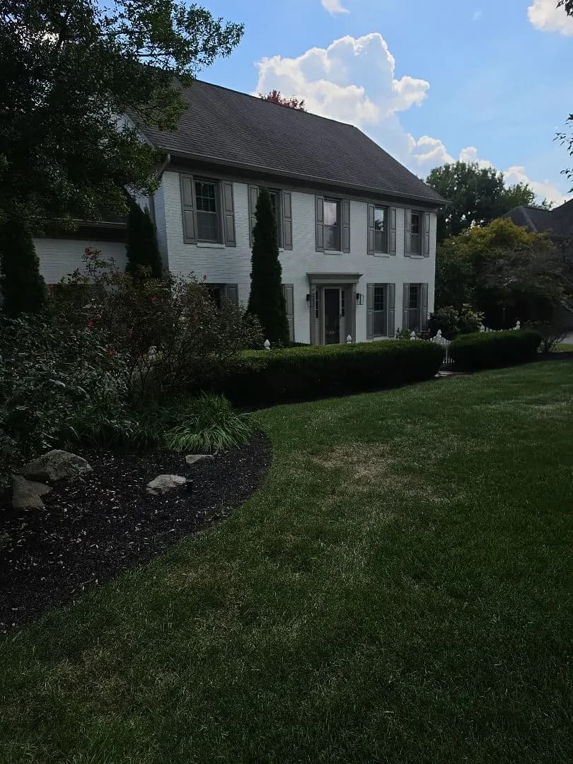 Two-story home with a dark shingle roof during a roof flashing repair in West Knoxville