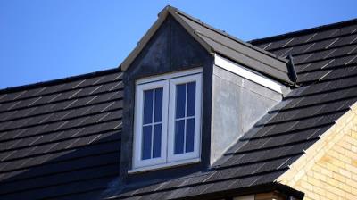 Newly installed roofing around a dormer window in Knoxville.